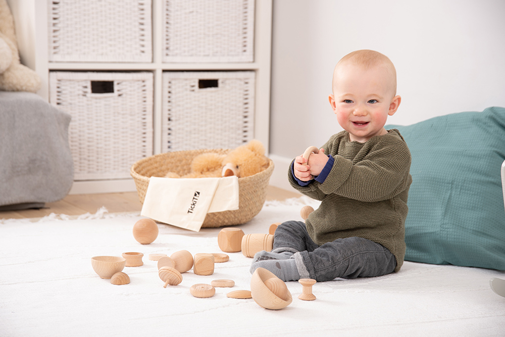 Baby playing with TickiT wooden heuristic play resources